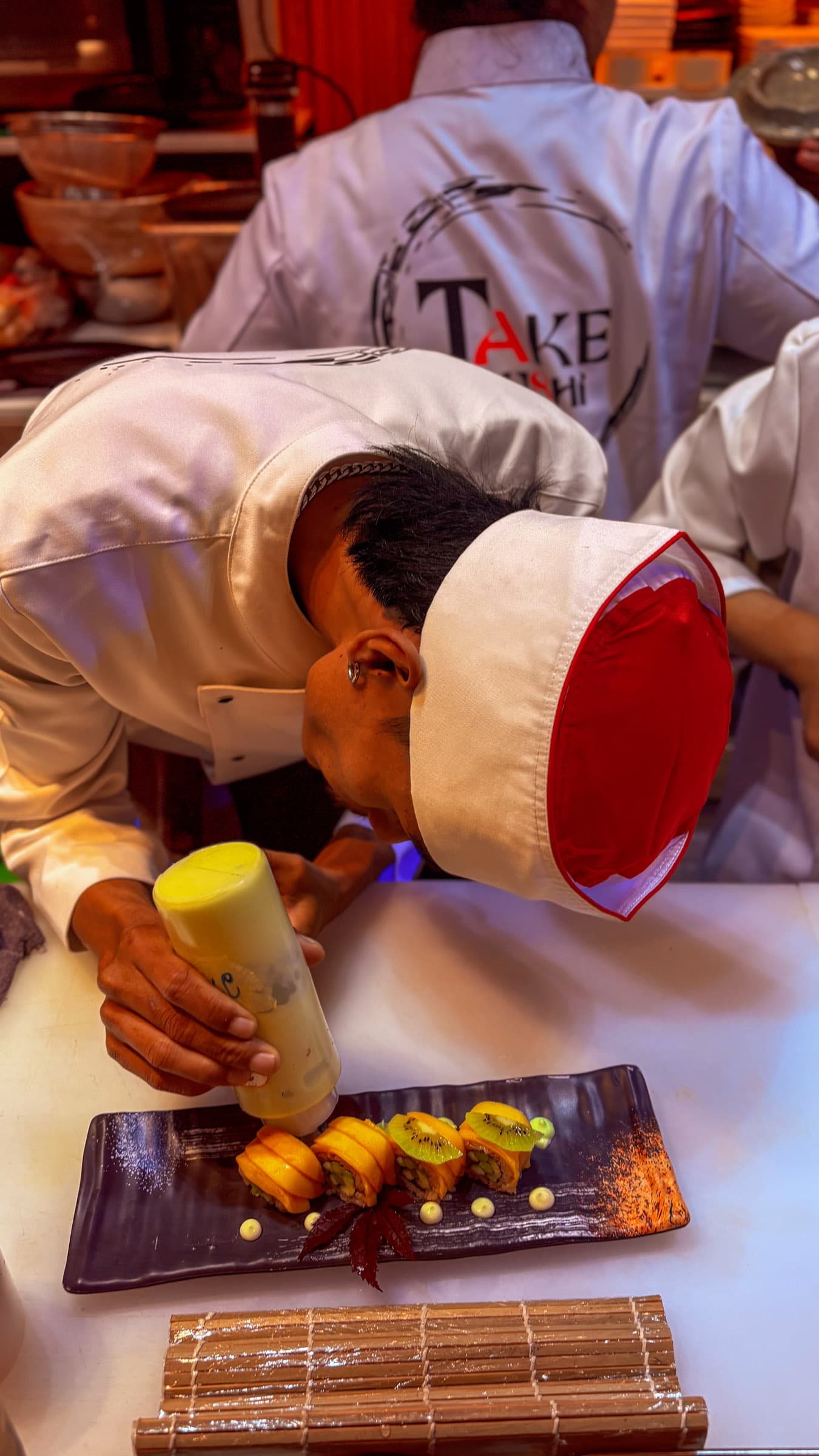 Chef carefully plating a signature sushi roll